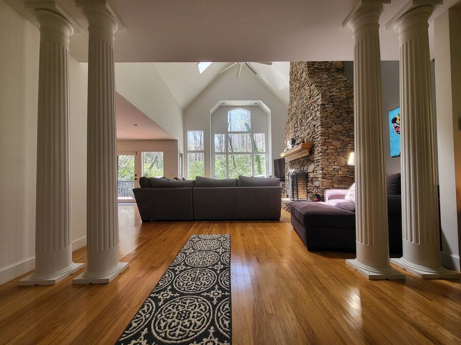 House for sale Franklin NC — grand living room with cathedral ceiling and stone fireplace
